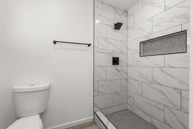 7525 Gill St NE, Albuquerque, NM 87109 - bathroom with tiled shower, toilet, and baseboards