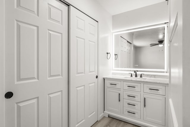7525 Gill St NE, Albuquerque, NM 87109 - bathroom with vanity, a ceiling fan, and wood finished floors