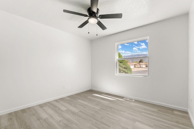 7525 Gill St NE, Albuquerque, NM 87109 - spare room featuring light wood-style floors, baseboards, and a ceiling fan