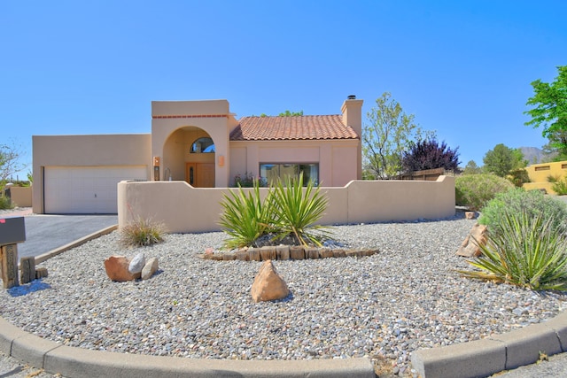 2865 Tramway Cir NE, Albuquerque, NM 87122 - view of front of property with a fenced front yard, a garage, driveway, a chimney, and stucco siding