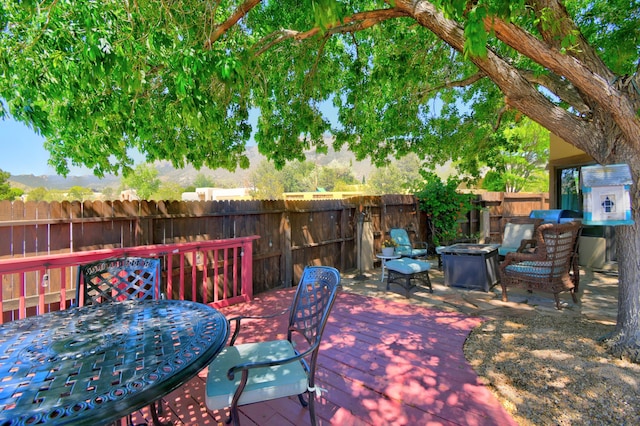 2865 Tramway Cir NE, Albuquerque, NM 87122 - wooden terrace with a fire pit and outdoor dining area