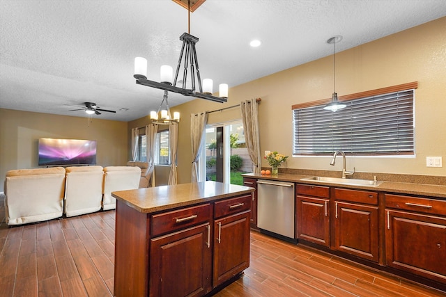 8935 Balsam Glade Rd NW, Albuquerque, NM 87114 - kitchen featuring stainless steel dishwasher, a sink, a textured ceiling, dark wood-type flooring, and a ceiling fan