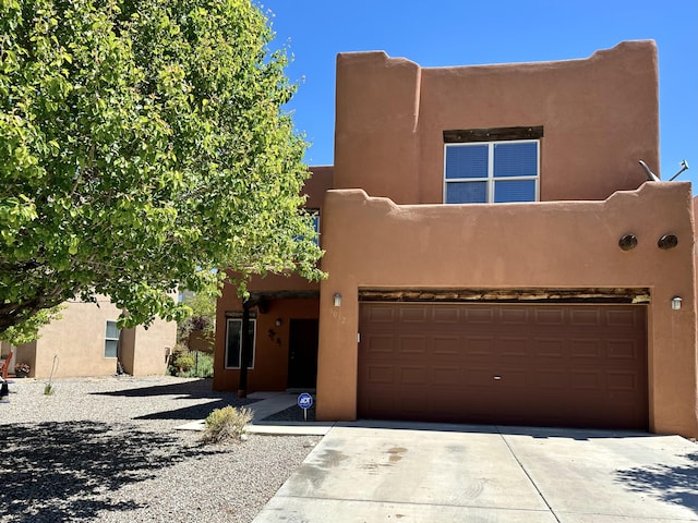 3032 Cochiti St NE, Rio Rancho, NM 87144 - southwest-style home with an attached garage, stucco siding, and driveway