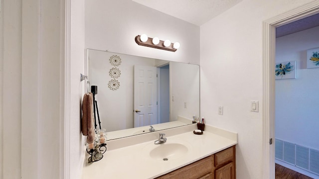 3032 Cochiti St NE, Rio Rancho, NM 87144 - bathroom featuring vanity and wood finished floors
