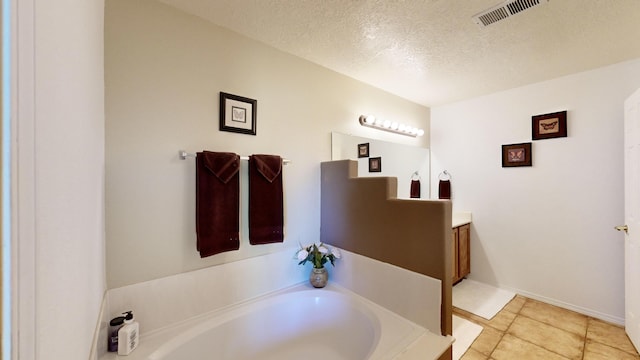 3032 Cochiti St NE, Rio Rancho, NM 87144 - full bath featuring vanity, a garden tub, a textured ceiling, tile patterned floors, and baseboards