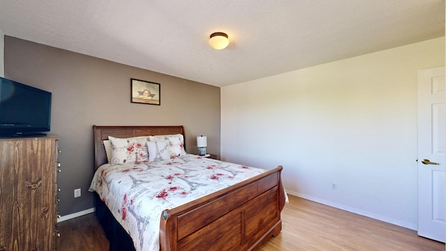 3032 Cochiti St NE, Rio Rancho, NM 87144 - bedroom with light wood-type flooring and baseboards