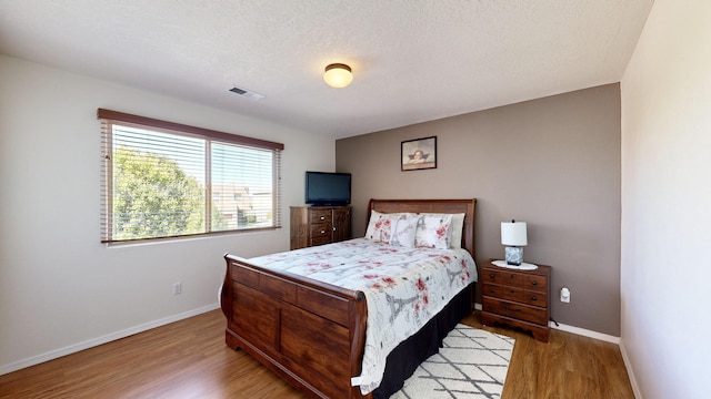 3032 Cochiti St NE, Rio Rancho, NM 87144 - bedroom featuring wood finished floors and baseboards