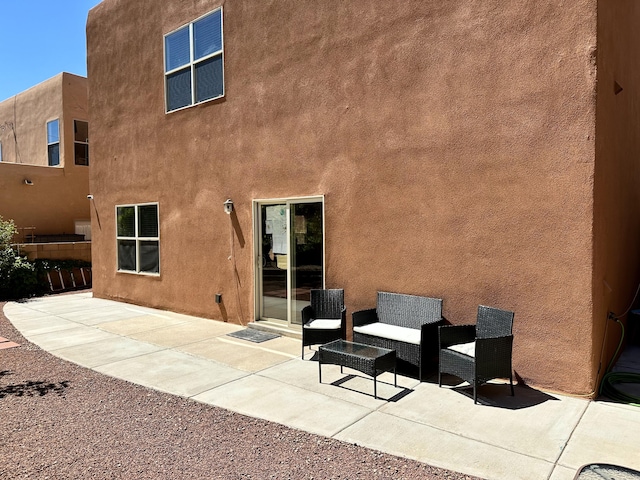 3032 Cochiti St NE, Rio Rancho, NM 87144 - rear view of property with a patio and stucco siding