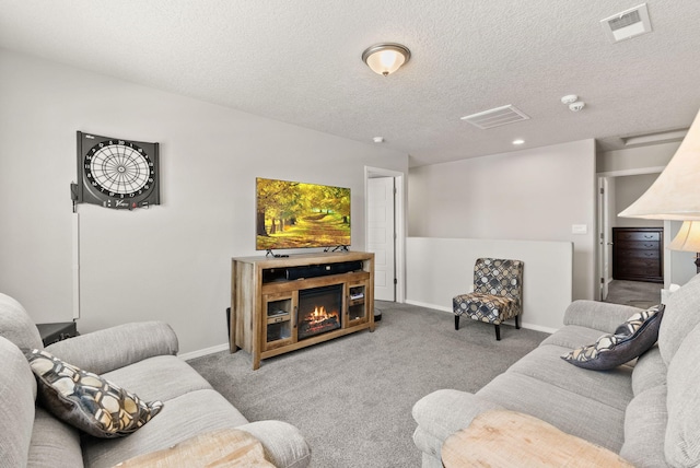 684 Turmalina Dr SE, Rio Rancho, NM 87124 - carpeted living area featuring baseboards, a glass covered fireplace, a textured ceiling, and recessed lighting