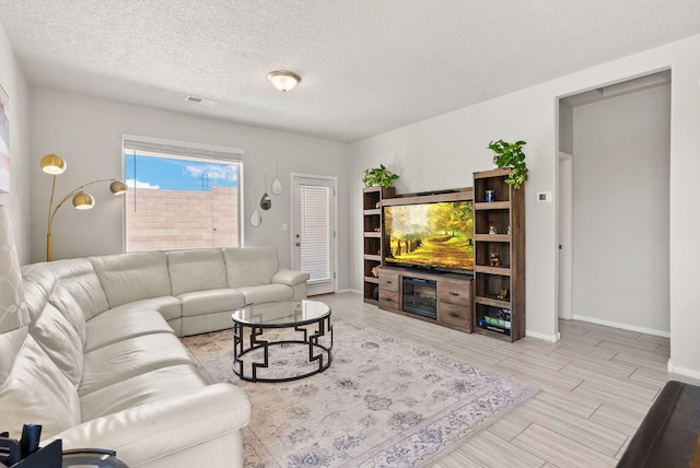 684 Turmalina Dr SE, Rio Rancho, NM 87124 - living area featuring baseboards, a textured ceiling, and wood finish floors