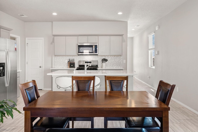 684 Turmalina Dr SE, Rio Rancho, NM 87124 - dining space featuring recessed lighting, baseboards, and a textured ceiling