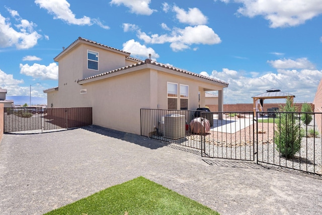 684 Turmalina Dr SE, Rio Rancho, NM 87124 - rear view of property featuring a gazebo, stucco siding, a patio, a tiled roof, and central air condition unit