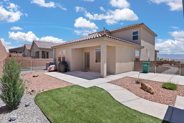 684 Turmalina Dr SE, Rio Rancho, NM 87124 - rear view of house with stucco siding, a tiled roof, a patio, and a gate