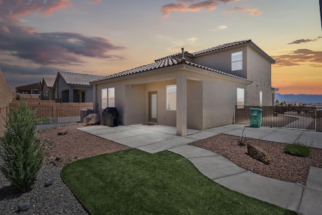 684 Turmalina Dr SE, Rio Rancho, NM 87124 - back of house with a patio, stucco siding, and a tile roof