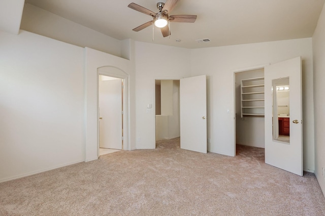 6501 San Antonio Dr NE Unit 2702, Albuquerque, NM 87109 - unfurnished bedroom featuring light carpet, a spacious closet, vaulted ceiling, and a closet