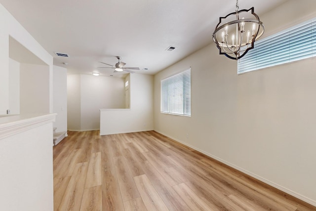 6501 San Antonio Dr NE Unit 2702, Albuquerque, NM 87109 - unfurnished room featuring a chandelier, light wood-type flooring, a ceiling fan, and baseboards