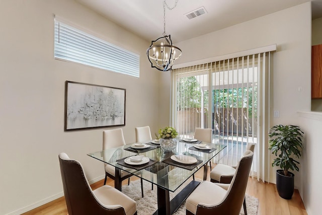 6501 San Antonio Dr NE Unit 2702, Albuquerque, NM 87109 - dining space with a chandelier, light wood finished floors, and baseboards