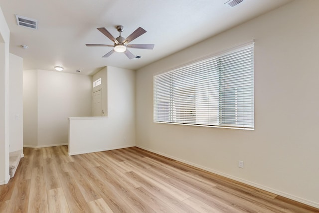 6501 San Antonio Dr NE Unit 2702, Albuquerque, NM 87109 - spare room with light wood finished floors, a ceiling fan, and baseboards