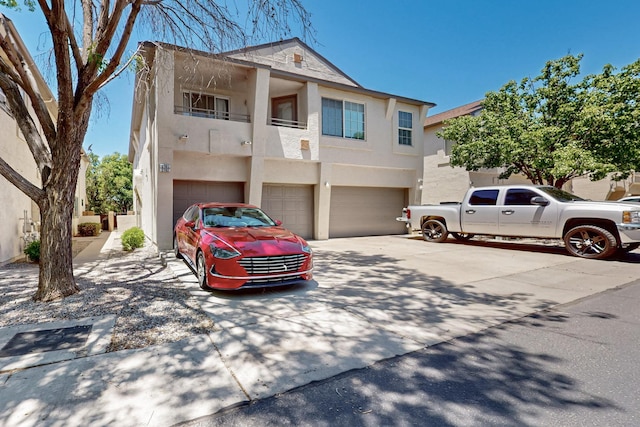 6501 San Antonio Dr NE Unit 2702, Albuquerque, NM 87109 - view of property featuring stucco siding, a garage, driveway, and a balcony