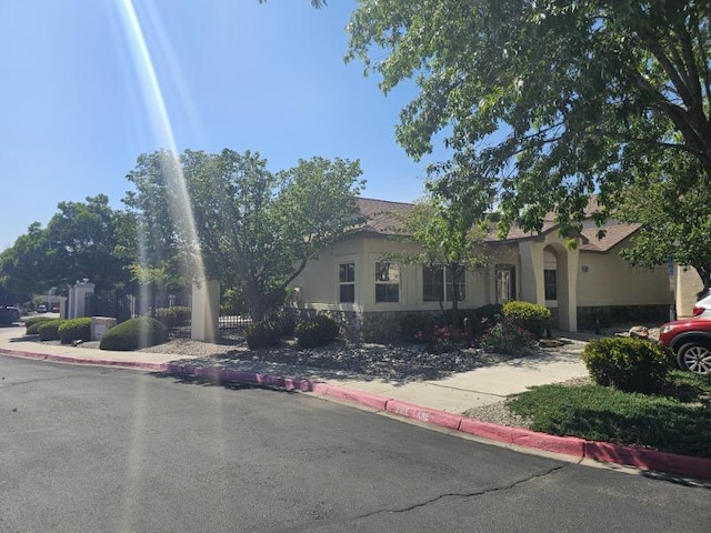 6501 San Antonio Dr NE Unit 2702, Albuquerque, NM 87109 - obstructed view of property with stucco siding