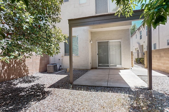 6501 San Antonio Dr NE Unit 2702, Albuquerque, NM 87109 - back of property with stucco siding, a patio area, and central air condition unit