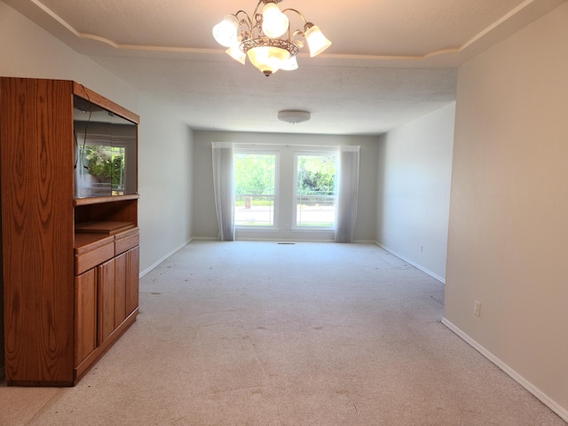 12708 Punta De Vista Pl NE, Albuquerque, NM 87112 - unfurnished room featuring light carpet, a chandelier, and baseboards