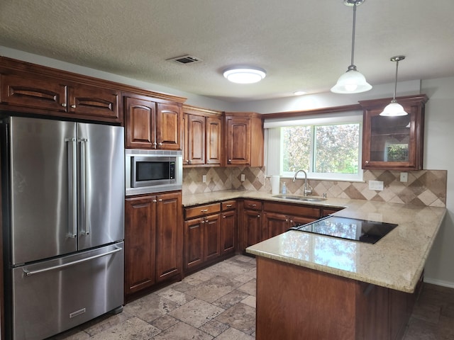 12708 Punta De Vista Pl NE, Albuquerque, NM 87112 - kitchen with stainless steel appliances, a sink, a peninsula, and decorative backsplash