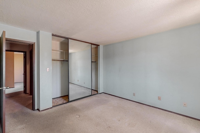 791 Stallion Rd SE, Rio Rancho, NM 87124 - unfurnished bedroom featuring carpet flooring, baseboards, a textured ceiling, and a closet