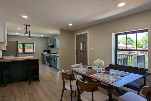 10031 Guadalupe Trl NW Unit A, Albuquerque, NM 87114 - dining space featuring light wood finished floors, recessed lighting, and a textured ceiling