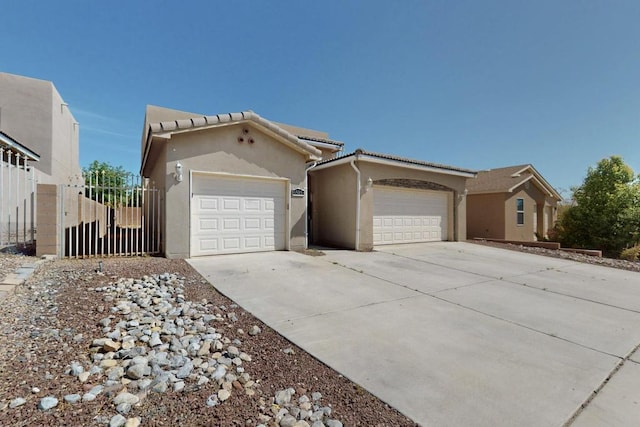 6505 Basket Weaver Ave NW, Albuquerque, NM 87114 - view of front of property with driveway, stucco siding, an attached garage, and a tiled roof