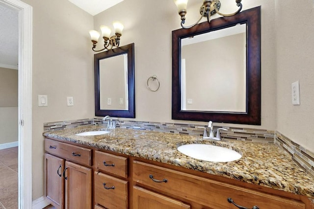 6505 Basket Weaver Ave NW, Albuquerque, NM 87114 - bathroom with a chandelier, double vanity, and baseboards