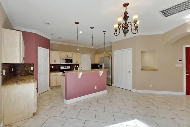 6505 Basket Weaver Ave NW, Albuquerque, NM 87114 - kitchen featuring appliances with stainless steel finishes, tasteful backsplash, ornamental molding, arched walkways, and a breakfast bar