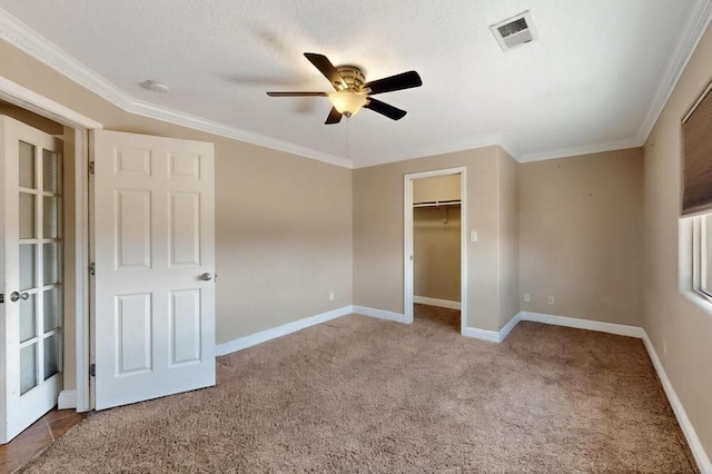 6505 Basket Weaver Ave NW, Albuquerque, NM 87114 - unfurnished bedroom with carpet floors, baseboards, crown molding, ceiling fan, and a spacious closet