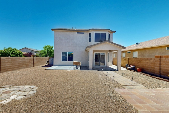 9731 Puccini Trl NW, Albuquerque, NM 87114 - back of house featuring stucco siding, a fenced backyard, and a patio area