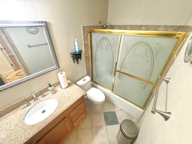 2119 Besler Ln SW, Albuquerque, NM 87105 - bathroom with vanity, toilet, shower / bath combination with glass door, and tile patterned flooring