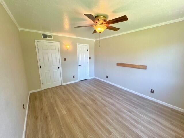 2119 Besler Ln SW, Albuquerque, NM 87105 - unfurnished bedroom featuring light wood-type flooring, baseboards, crown molding, and a ceiling fan