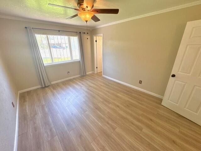 2119 Besler Ln SW, Albuquerque, NM 87105 - unfurnished room with wood finished floors, crown molding, ceiling fan, and baseboards