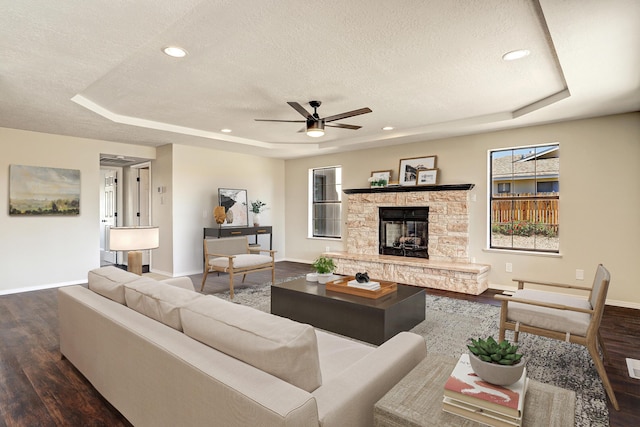 564 Nicklaus Dr SE, Rio Rancho, NM 87124 - living area with a tray ceiling, a textured ceiling, baseboards, wood finished floors, and ceiling fan