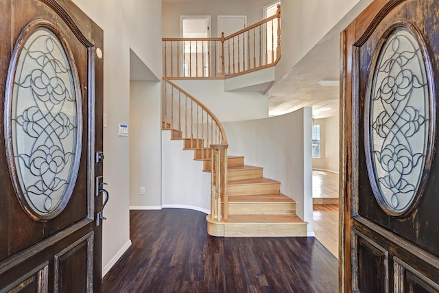 564 Nicklaus Dr SE, Rio Rancho, NM 87124 - foyer entrance with wood finished floors, baseboards, stairs, and a towering ceiling