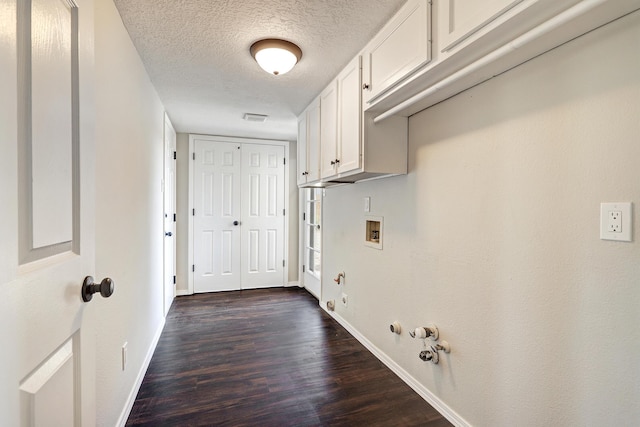 564 Nicklaus Dr SE, Rio Rancho, NM 87124 - laundry room with hookup for a gas dryer, dark wood-type flooring, cabinet space, baseboards, and hookup for a washing machine