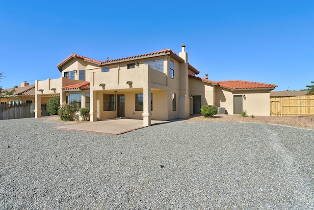 564 Nicklaus Dr SE, Rio Rancho, NM 87124 - rear view of property featuring a tile roof, stucco siding, a patio area, and cooling unit