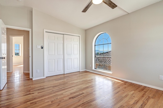 564 Nicklaus Dr SE, Rio Rancho, NM 87124 - unfurnished bedroom featuring vaulted ceiling, light wood-type flooring, baseboards, a closet, and ceiling fan