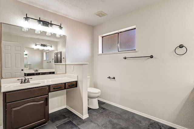 564 Nicklaus Dr SE, Rio Rancho, NM 87124 - bathroom featuring toilet, vanity, and baseboards