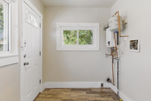 417 8th St NW, Albuquerque, NM 87102 - laundry area featuring wood finished floors and water heater