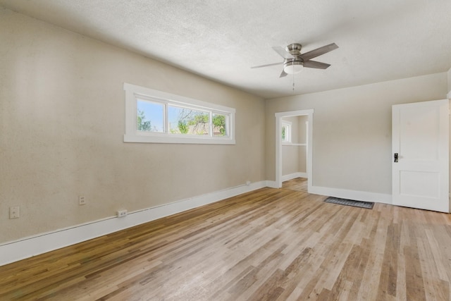 417 8th St NW, Albuquerque, NM 87102 - unfurnished bedroom featuring multiple windows, light wood-style flooring, baseboards, and ceiling fan