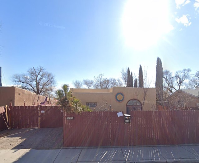 804 Hardy Ave SW, Albuquerque, NM 87105 - view of front of house with stucco siding, a fenced front yard, and a gate