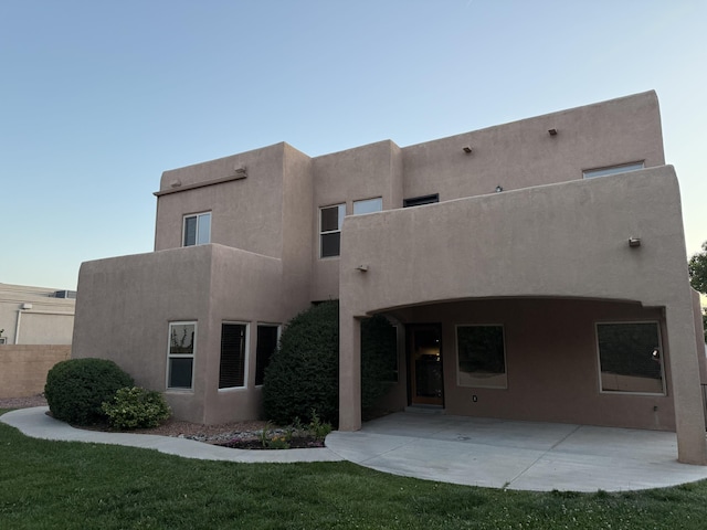 8212 Grape View Ct NE, Albuquerque, NM 87122 - rear view of house with stucco siding, a patio, and a yard