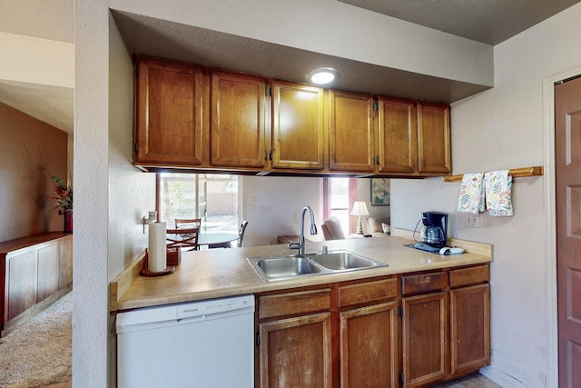 2004 Western Hills Dr NE, Rio Rancho, NM 87124 - kitchen featuring dishwasher, a sink, brown cabinets, and light countertops
