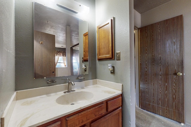 2004 Western Hills Dr NE, Rio Rancho, NM 87124 - bathroom featuring vanity and a textured wall