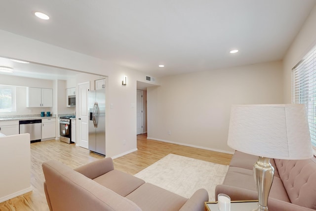 1825 Hiawatha Ct NE, Albuquerque, NM 87112 - living room with plenty of natural light, light wood finished floors, recessed lighting, and baseboards